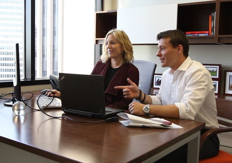 a-partner-meets-with-an-employee-to-discuss-project-updates